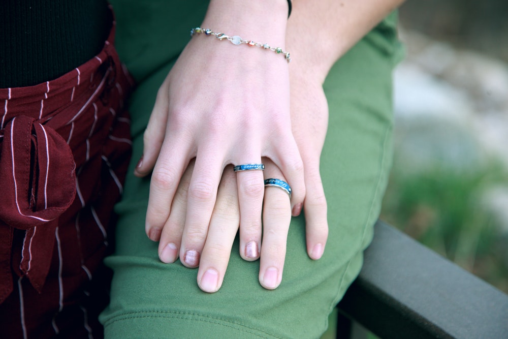 What is The Difference Between Promise and Engagement Rings? hand in hand